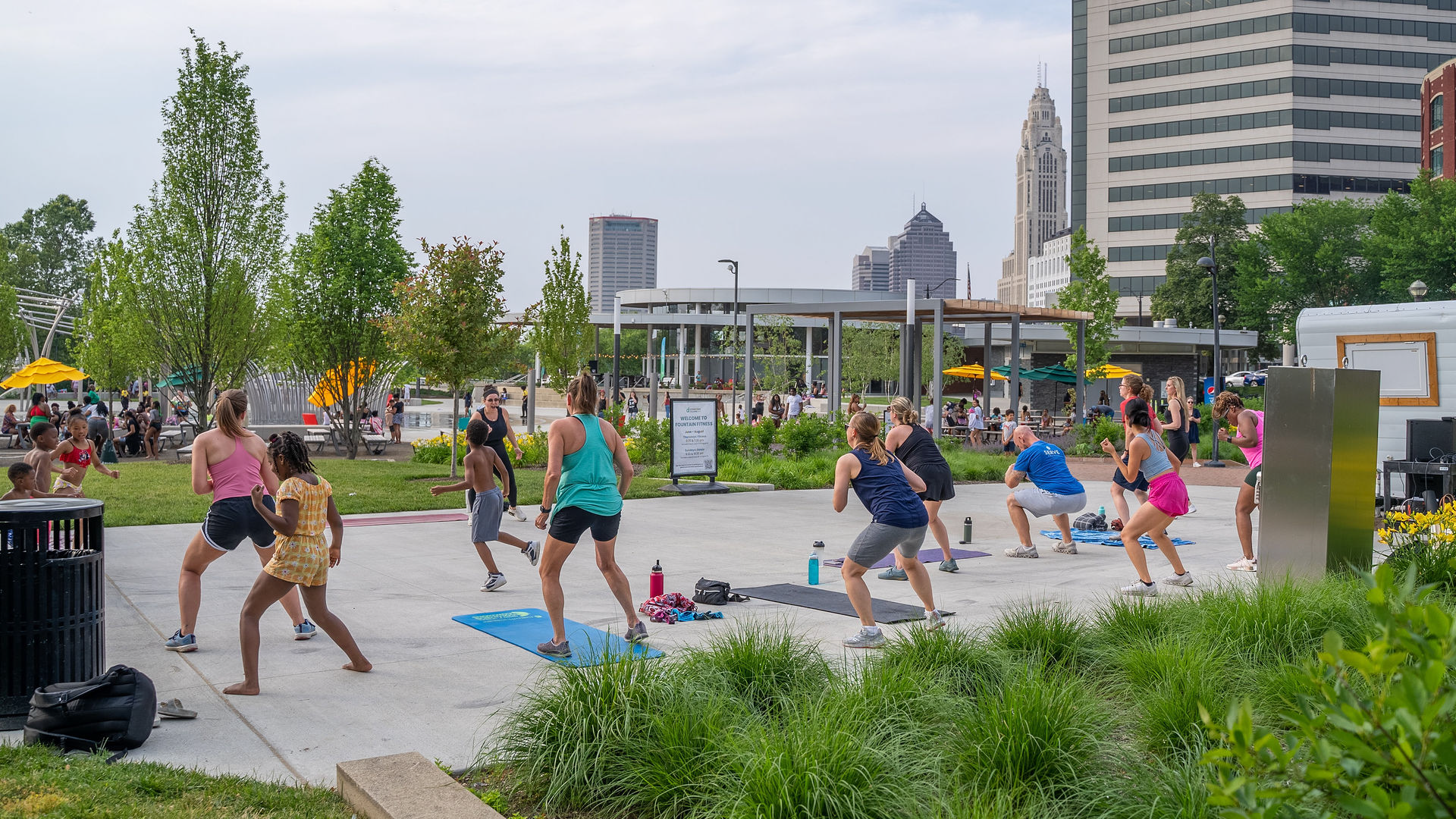 A group of people working out during an outdoor downtown fitness class.