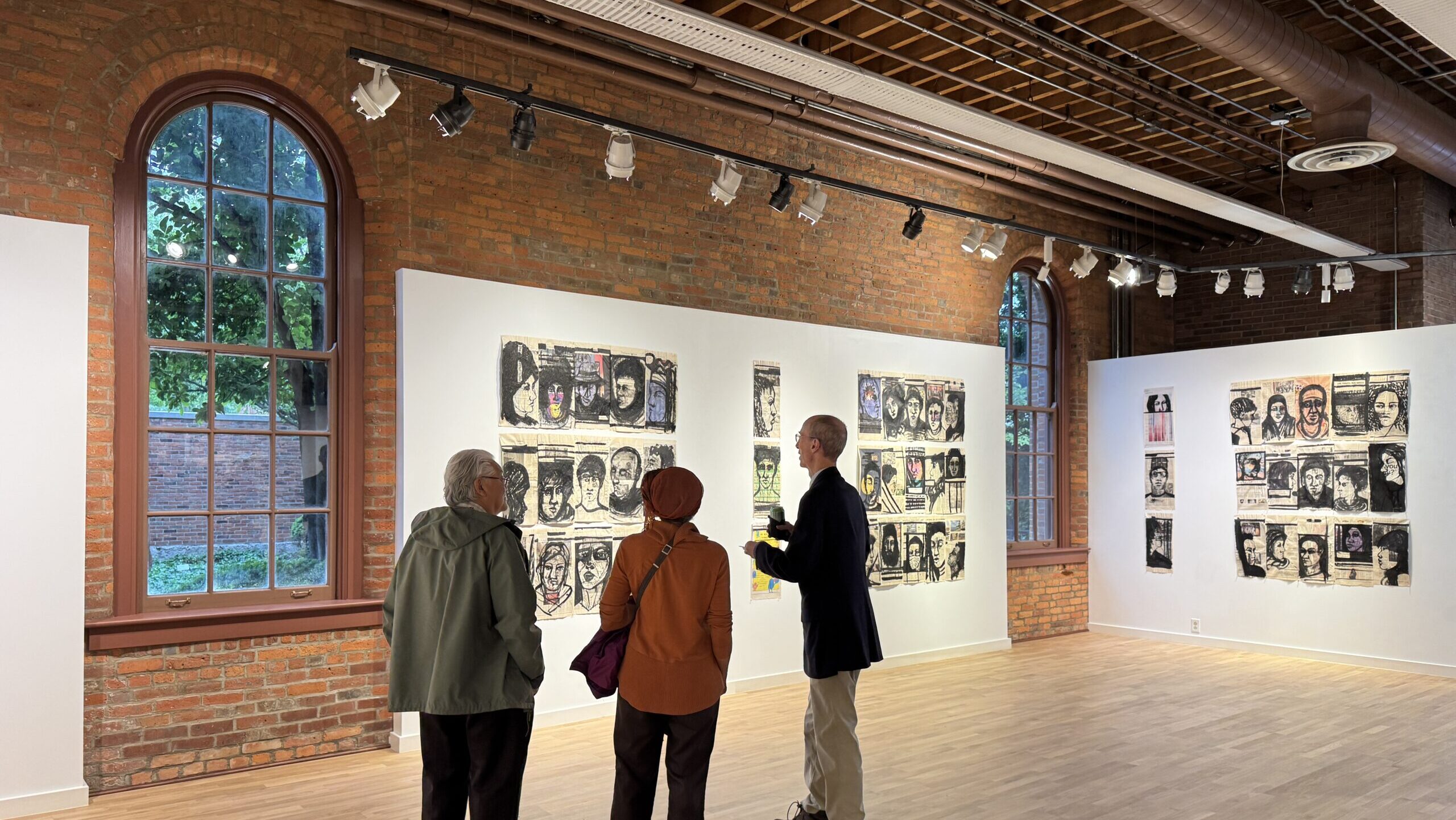 People viewing art exhibit in gallery